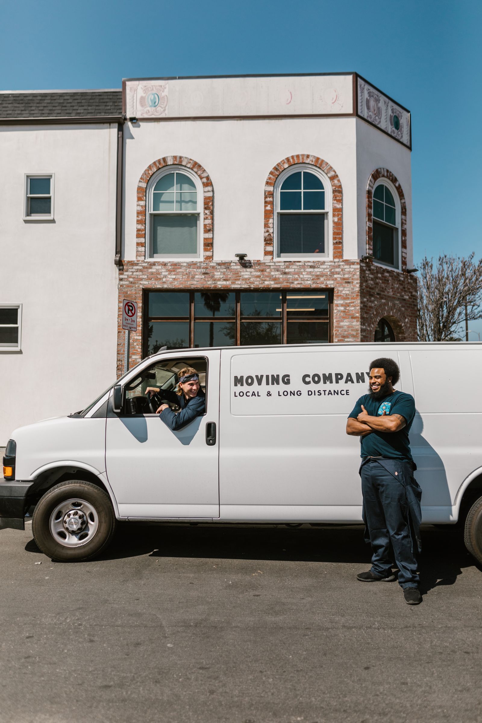 Moving van parked outside a brick building